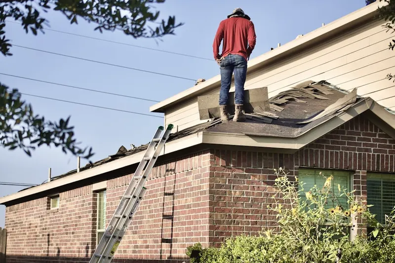 Professional roofer working on a residential roof in Near Eastside